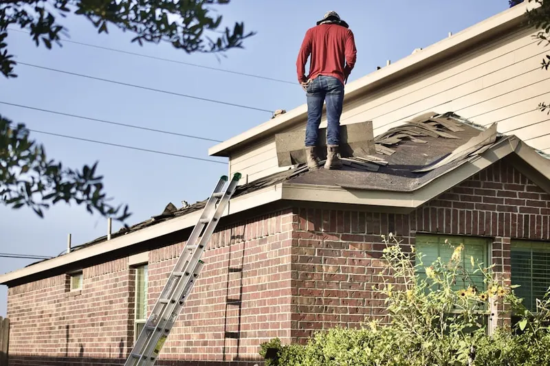 Professional roofer working on a residential roof in Snydersville